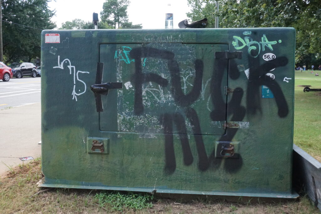 A spray-painted electrical box near Piedmont Park bearing the phrase "Fuck III%"